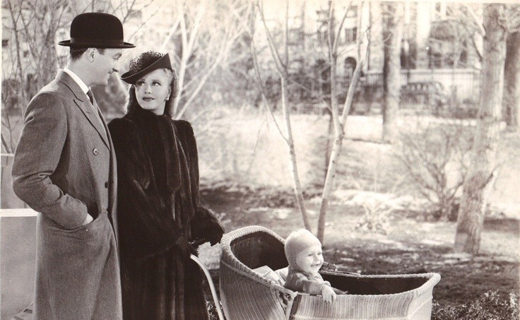 Ginger Rogers and David Niven pushing a stroller with a happy baby in Bachelor Mother (1939)